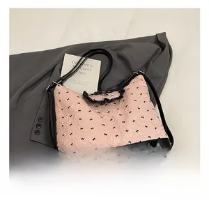 Detail of pink bubble fabric tote with black bow prints and ruffled trim accents