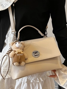 Cream white rectangular leather tote bag with a cute bear charm and silver twist lock