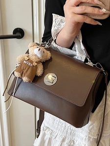 Women's deep brown PU leather shoulder bag with silver turn-lock and plush bear charm