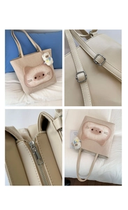 Detailansicht der Cord-Eimertasche mit Katzenmotiv, Trageriemen und Schaf-Anhänger