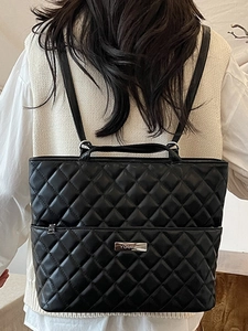 Minimalist black quilted tote backpack with diamond pattern and metal logo for women