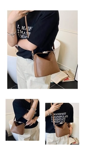 Detail of brown lychee grain leather handbag with silver clasp and embossed logo
