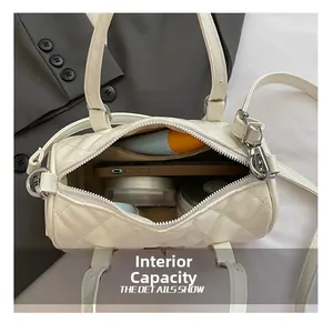 Internal capacity of the white quilted cylinder handbag showing daily essentials and space