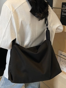 2025 retro large black crossbody canvas bag with wide shoulder strap shown on model