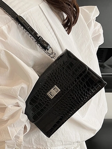 Classic black crocodile pattern crossbody bag with silver chain strap and metal lock