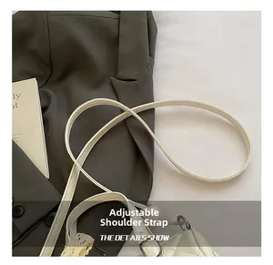 Close-up of adjustable shoulder strap and silver buckle on white quilted pillow bag