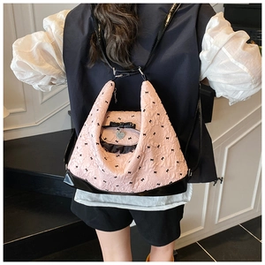 Detail of pink bubble texture bag with black ribbon bows and heart metal pendant