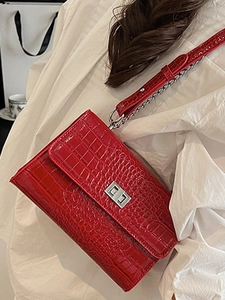 Red crocodile texture crossbody bag with silver chain strap and metallic buckle