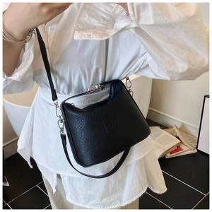 Litchi texture black leather bucket bag with silver hardware on a fashion model