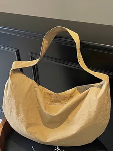 Minimalist khaki woven tote bag with pleated texture and stylish crescent shape