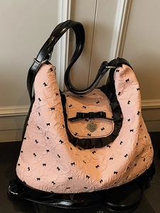 Pink pleated tote bag with black bows and ruffled trim in a retro sweet aesthetic style