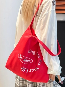 Minimalist red canvas shoulder bag featuring a white printed letter logo and large capacity