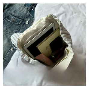 Spacious interior of striped canvas backpack showing capacity for tablet and books