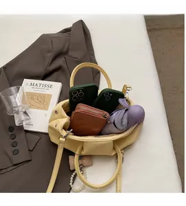 Interior view showing spacious capacity of the yellow pleated tote bag with essentials