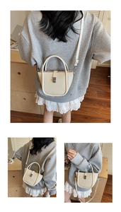 Détails de la texture tissée du sac à main blanc crème avec boucle en métal argenté