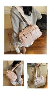 Detail view of pink retro bowling bag with metal buckle pockets and wide strap