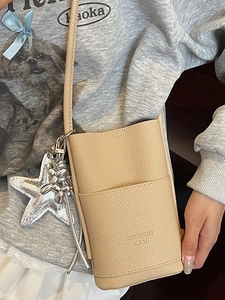 Chic apricot pebble leather crossbody phone bag with trendy metallic charms