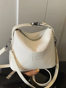 Chic beige lychee textured leather handbag with S.Y.B. BAG embossing and crossbody strap