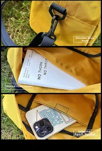 Detail view of yellow nylon sports bag showing strap hook and internal zip pocket details