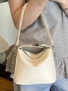 Chic beige lychee leather tote bag with silver buckle and crossbody strap for women