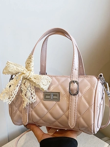 Pink quilted cylinder boston bag with glossy finish and delicate lace bow accent