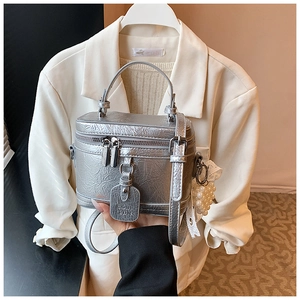 Silver metallic square handbag with pearl and lace bow charm detail and shoulder strap