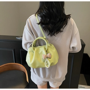 Detail view of the soft pleated texture and cloud design on this green crossbody bag