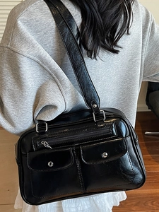 Retro black bowling bag in glossy wax leather finish for casual shoulder and crossbody use