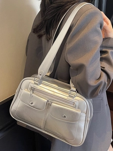 Metallic silver bowling bag for women featuring dual front pockets and shoulder strap