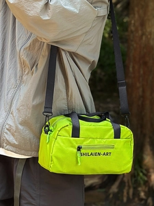Neon green sporty crossbody bag for women with black nylon straps and front zipper pocket