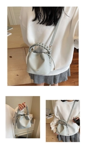 Detailed views of light blue lychee pattern bucket bag with woven handle and strap