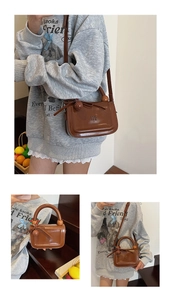 Dettaglio borsa vintage marrone con manico tubolare e decorazione a fiocco elegante