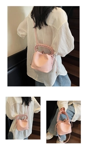 Detail of pink lychee pattern bucket bag featuring woven handle and drawstring closure