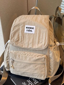 Minimalist cream nylon drawstring backpack with flap and large capacity for travel