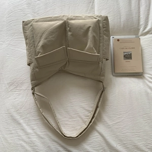 Detailed view of beige large capacity canvas messenger bag with dual front flap pockets