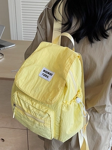 Minimalist light yellow nylon backpack with drawstring flap and large capacity for travel