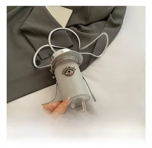 Silver cylinder bag with hat-shaped lid, rhinestone eyes, and decorative legs