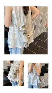Detail of silver robot-shaped crossbody bag with glitter finish and evil eye motif