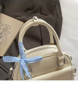 Detailansicht der cremefarbenen Boston Bag mit Reißverschluss und blauem Karoband