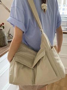 Large beige canvas messenger bag for women with multi-pockets and wide shoulder strap