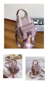 Detail of dusty pink nylon mini bag with front zipper pocket and woven top handle