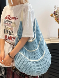 Handcrafted blue and white woven hobo shoulder bag with a spacious minimalist design