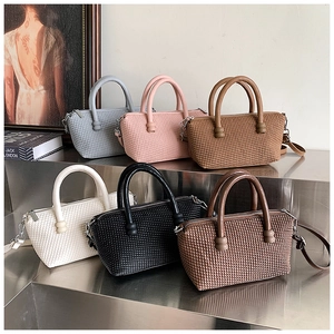 Detailed view of woven texture small square bags in six colors with spherical ornaments