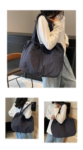 Detail view of large nylon tote bag with drawstring closure and front double pockets
