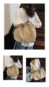 Detail view of khaki nylon tote bag with drawstring closure and soft pleated texture
