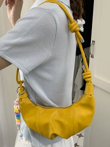 Chic yellow half-moon croissant bag with vibrant beads and knotted leather strap