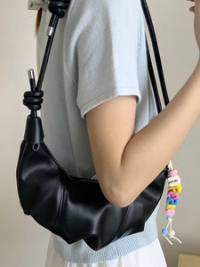 Chic black half-moon crossbody bag with decorative letter beads and knotted strap