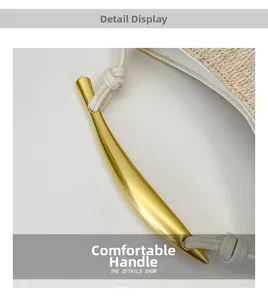 Detail show of straw woven bag featuring a white leather strap and golden horn metal handle
