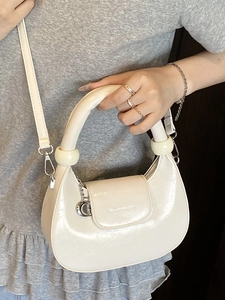 Chic beige crescent hobo bag with pearl-luster finish and cylindrical top handle