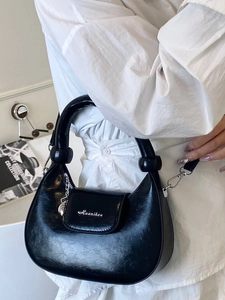 Fashionable black patent leather crescent hobo bag for women with chain detail and top handle